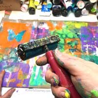 Video showing how the layers built up with gelli printing® and mask on a paper bag for the Let’s Play link party