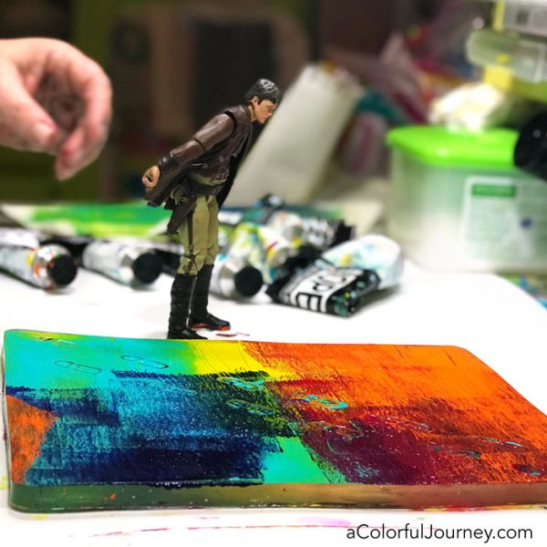 Gel printing with a toy action figure and Golden Open paints on a Gel Press Plate video tutorial by Carolyn Dube
